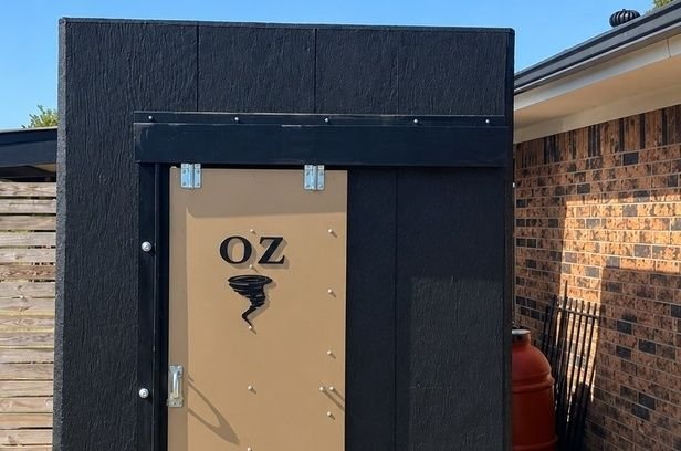 After: concrete storm shelter painted black for a clean finished look