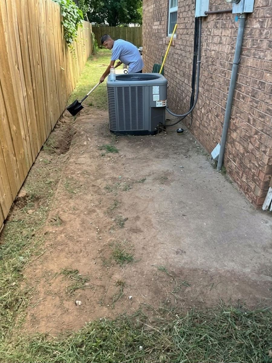 Before: muddy side yard with dirt washed over the walkway by the AC unit
